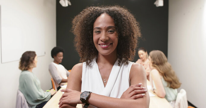 Portrait of happy casual businesswoman in meeting room