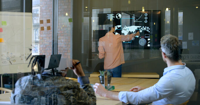 Business executives discussing over digital screen