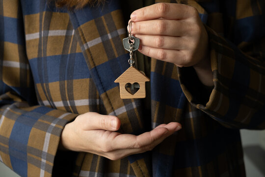 New owner of house holding keys in her hand. Moving, buying real estate.