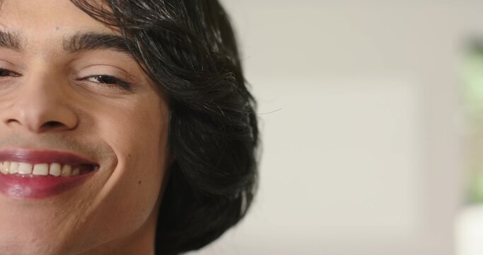 Adult male smiling and showing dimple and teeth while occupying left side of frame at home