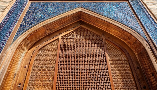 carved wooden door with pointed arch and honeycomb lattice at chor minor in bukhara uzbekistan historic islamic architectural detail ideal for travel and heritage publications