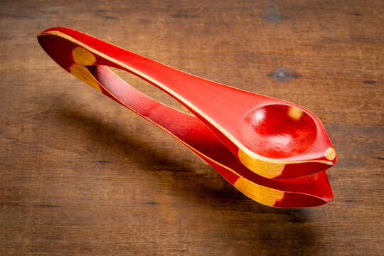 Wooden musical spoons, folk percussion instrument on grunge wood