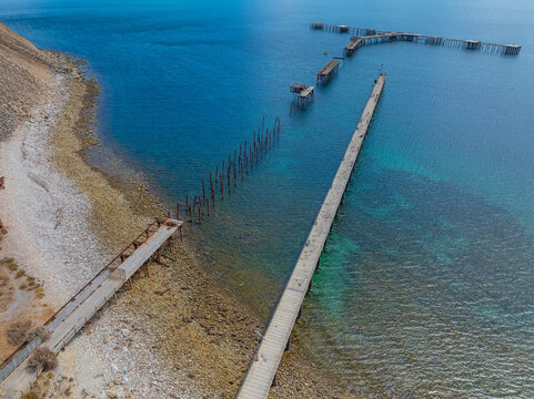 Sections of an old abandoned jetty alongside a new replacement