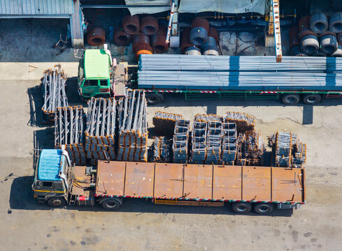 Aerial View Steel Factory Yard with Rebar, Trucks and Metal Mate