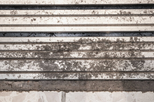 Aluminium elevator track with fire damage and soot buildup. Top view. Large sections of staining and corrosion. Cleaning and maintaining metal concept. Selective focus