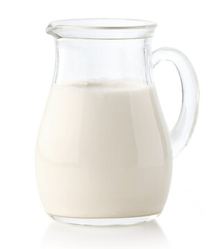 Glass jug or pitcher of fresh milk on white background