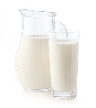 Jug or pitcher and glass of fresh milk on white background