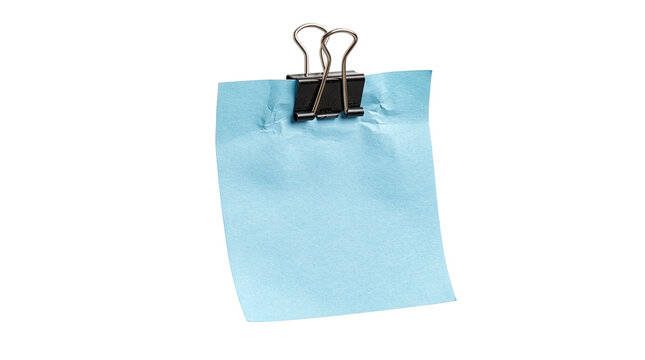 Light blue memo sheet clipped at the top with a black metal binder clip