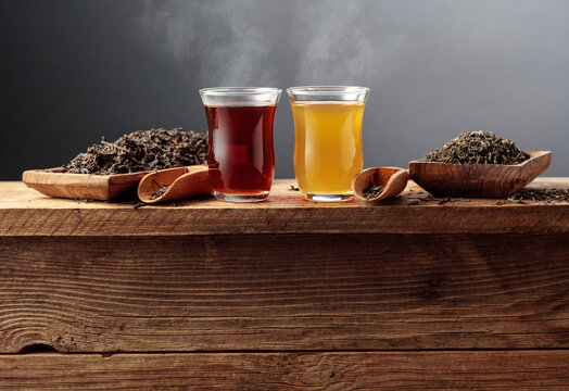 Black and green tea on an old wooden table.
