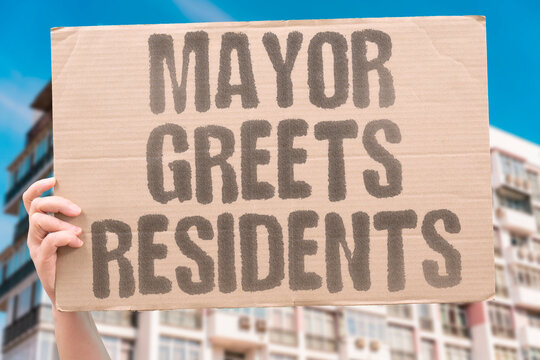 "Mayor greets residents" A newly elected town leader who fled war shakes hands with new neighbors. MAYOR. GREETS. RESIDENTS. ELECTED. NEIGHBORS.