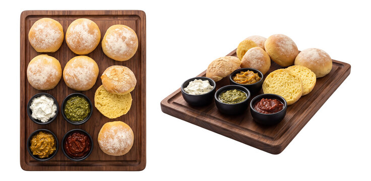 crusty potato rolls with savory spreads and dips on a wooden serving board