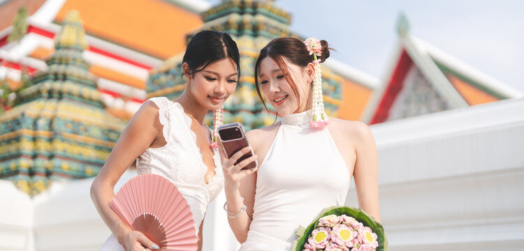  Two young asian women sightseeing in Bangkok, Thailand trend fashion with oriental aesthetic flower accessories
