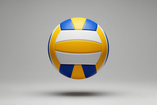 Yellow, blue and white volleyball floating against a gray background. Volleyball sport and indoor court game. Team competition, athletic training and recreation.