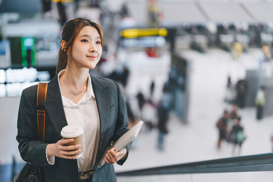 Asian businesswoman wear blazer at international airport terminal departure platform business trip work and travel
