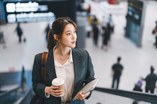 Asian businesswoman wear blazer at international airport terminal departure platform business trip work and travel