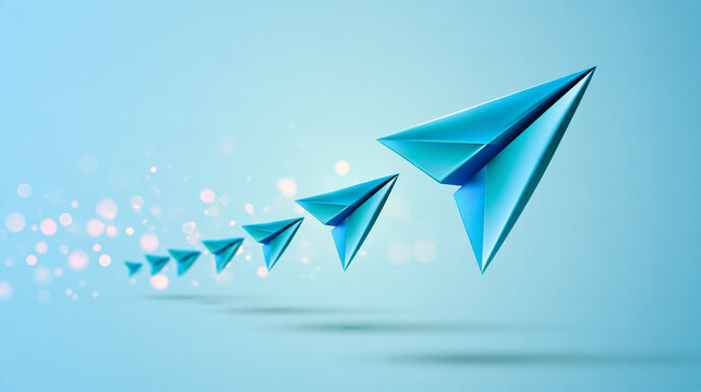 Blue paper airplanes flying in formation against a light blue background, symbolizing progress, innovation, and teamwork.