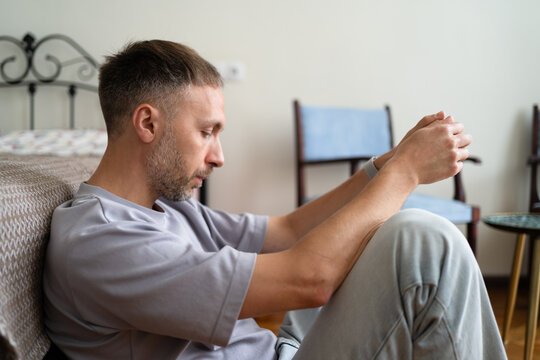 Midlife Crisis, Anxiety About Future and Life Decisions, Worried Man Sitting Alone at Home.