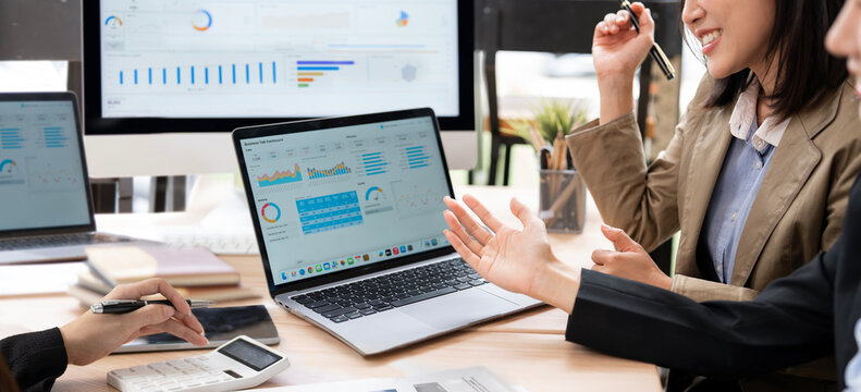 Business Team Analyzing Financial Reports and Discussing Strategy in Office Meeting