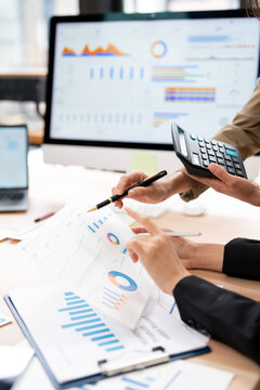 Vertical Close Up of Business Team Analyzing Financial Reports and Data in Office