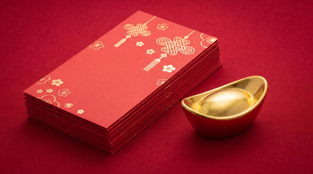 Stack of red envelopes with gold ingot on red background