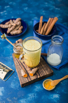 Golden milk with turmeric and spices in a glass mug