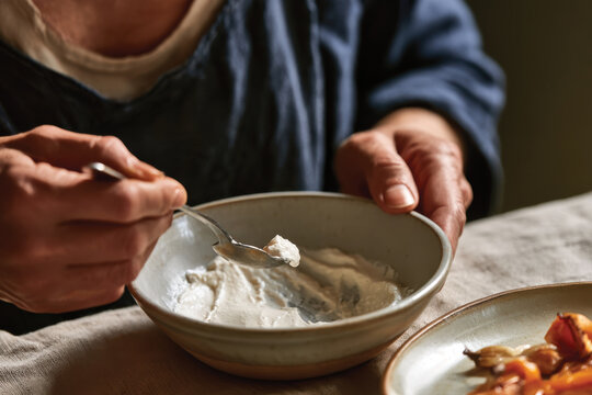 A serene image of an individual savoring a bowl of hearty dish showcasing a mix of flavors, emphasizing the everyday joy of enjoying nutritious meals and culinary experiences.