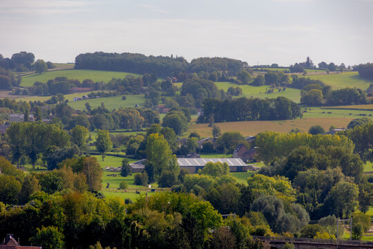 Autumn landscape, The terrain hilly countryside in border of Netherlands and Belgium, A small villages and houses on hillside with farmland and forest, Sint-Martens-Voeren, Belgian province of Limburg