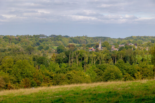 The terrain hilly countryside with houses and green grass meadow under blue sky in Autumn, Noorbeek is a village in the Dutch province of Limburg, The municipality of Eijsden-Margraten, Netherlands.