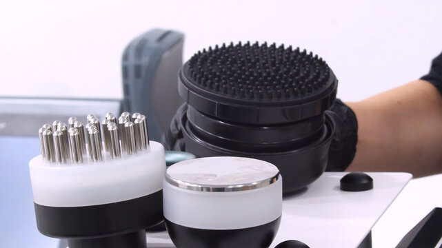Professional body shaping therapy with vibromassage thermo vacuum and bioelectrical stimulation in beauty salon. 