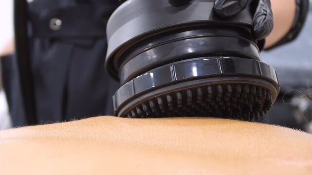 Professional body shaping therapy with vibromassage thermo vacuum and bioelectrical stimulation in beauty salon. 