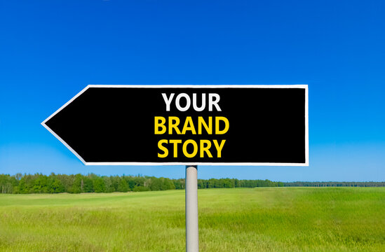 Branding and your brand story symbol. Concept words Your brand story on beautiful black road sign. Beautiful blue sky green grass background. Business branding your brand story concept. Copy space.