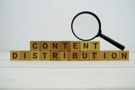 Content Distribution alphabet letters with magnifying glass on wooden background
