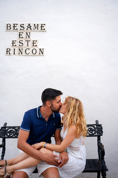 Couple Kissing On Bench