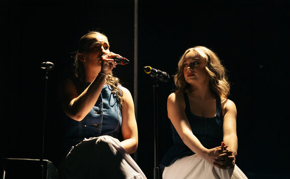 Two performers singing together
