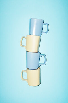 Assembly of pastel coloured light yellow blue ceramic coffee cups